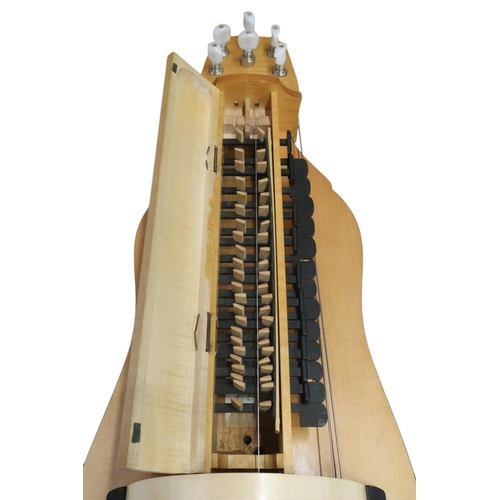 623 - A Contemporary Hurdy-Gurdy, with a flat back and mechanical tuning pegs, with a hard case containing... 