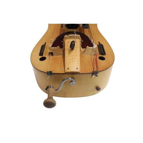 623 - A Contemporary Hurdy-Gurdy, with a flat back and mechanical tuning pegs, with a hard case containing... 