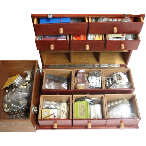 628 - A chest of drawers containing instrument repair parts to include, tuning pegs, banjo hex nuts, mothe... 