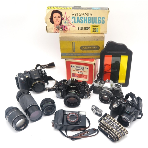 503 - A large quantity of camera equipment, to include a Canon A-1 camera fitted with an FD 50mm 1:1.8 len... 