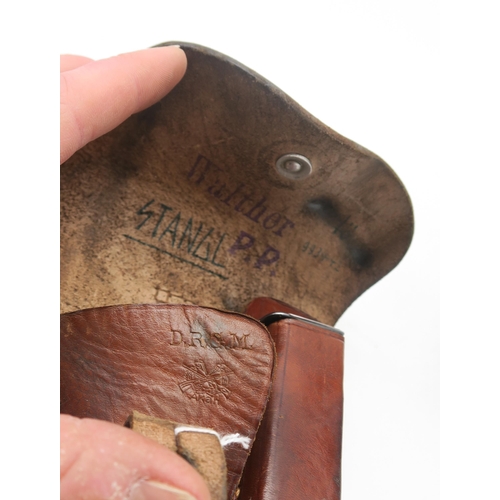 514 - A Walther PP leather holster, housing an empty magazine; together with a cased pair of WW1-period Ca... 