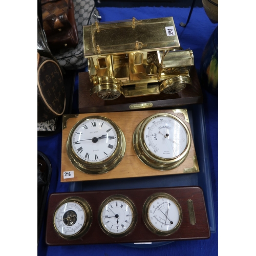 298 - A brass model of a vintage taxi and two barometers