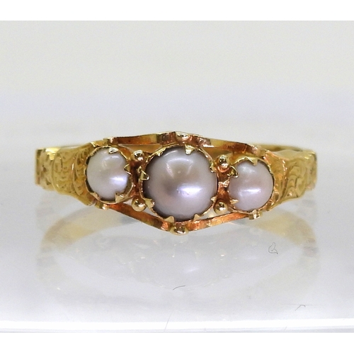 2702 - AN ANTIQUE PEARL RINGthe bright yellow metal scrolled mount with engraved detail to the shoulders. S... 