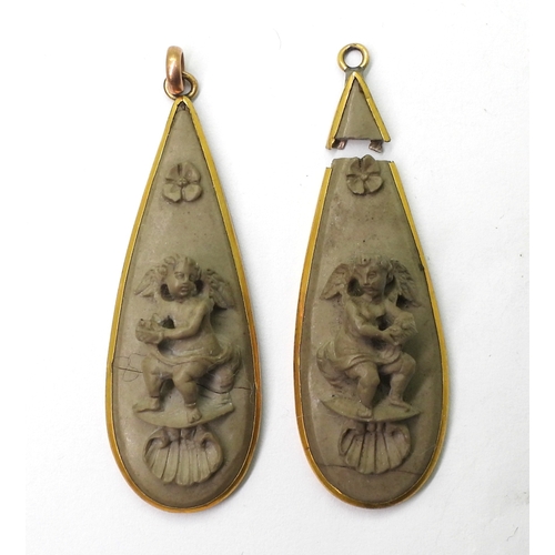 2707 - A PAIR OF LAVA EARRINGSboth carved with cherubs, flowers and shells. Both need some TLC and a pair o... 