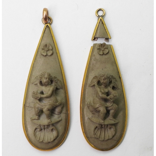 2707 - A PAIR OF LAVA EARRINGSboth carved with cherubs, flowers and shells. Both need some TLC and a pair o... 