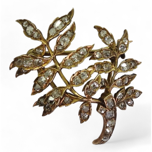 2715 - A DIAMOND BROOCHthe yellow metal leaf frond shape set throughout in old cut diamonds. With an estima... 