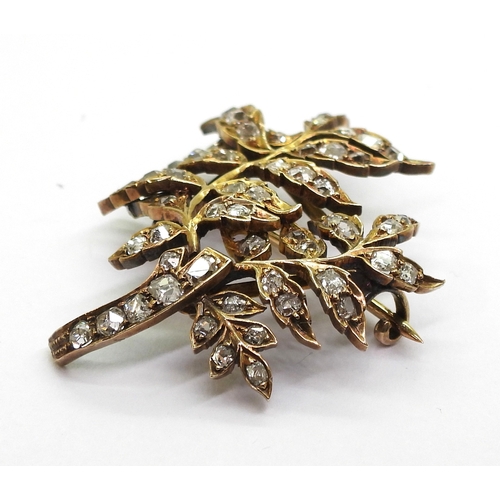 2715 - A DIAMOND BROOCHthe yellow metal leaf frond shape set throughout in old cut diamonds. With an estima... 