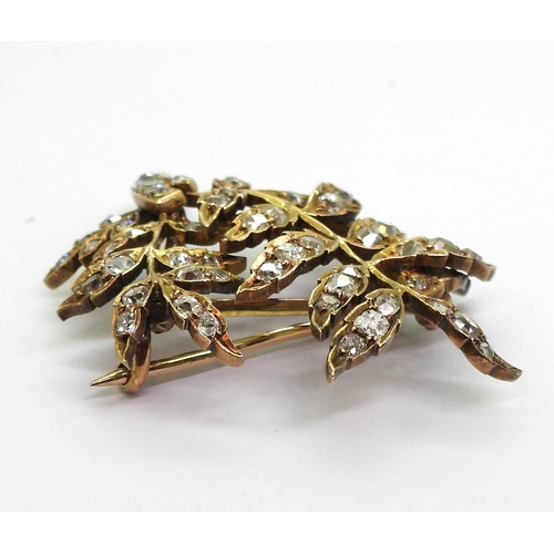 2715 - A DIAMOND BROOCHthe yellow metal leaf frond shape set throughout in old cut diamonds. With an estima... 