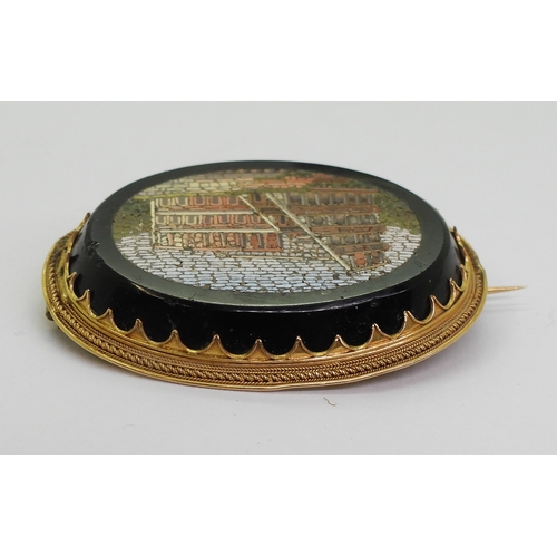 2719 - A MICRO MOSAIC BROOCHdepicting the Colosseum, in a yellow metal brooch mount, the pin is stamped wit... 