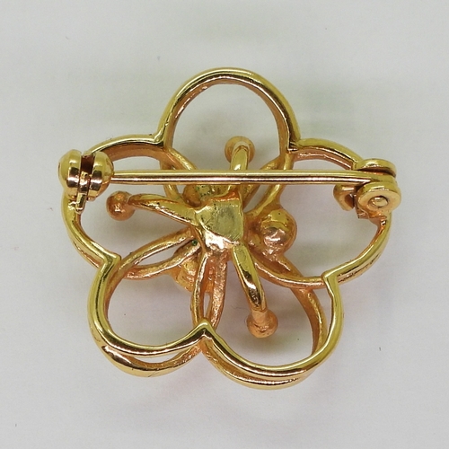 2722 - TWO BROOCHESa bright yellow metal knot shaped brooch, set with old cut diamonds with an estimated ap... 