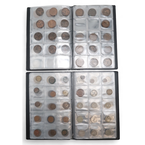 464 - A collection of worldwide coins in two collector's folders to include 1873 Liberty Dollar and a 1901... 