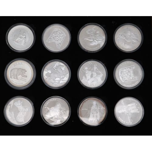 355 - A lot comprising 24 1 oz silver coins various designers cased