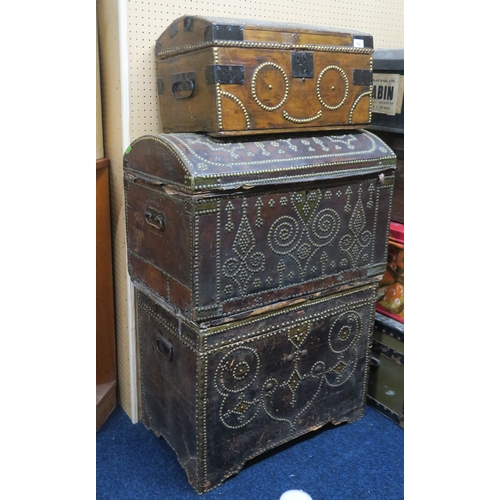 102 - A lot comprising a large hide bound travel trunk with studded decoration, another hide bound dome to... 