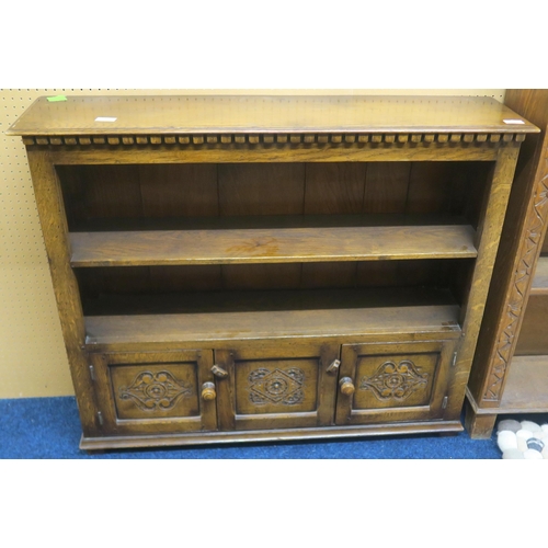 120 - A 20th century elm open bookcase with two open shelves over two cabinet doors on plinth base, 86cm h... 