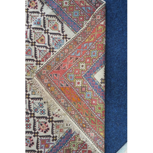 29 - A beige ground Caucasian rug with all over geometric floral patterned ground within multiple multico... 