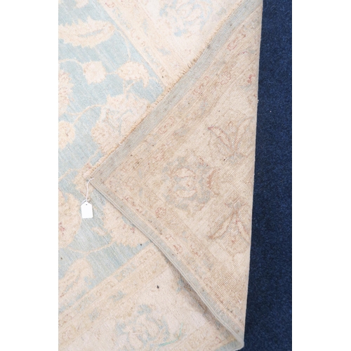 40 - A turquoise ground Zeigler rug with cream all over floral/foliate patterned ground within cream flor... 