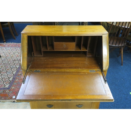 41 - A 20th century walnut veneered writing bureau with fitted fall front writing compartment over three ... 