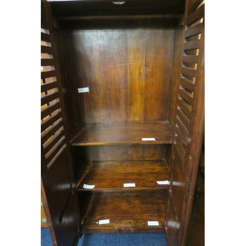 47 - A 20th century hardwood narrow wardrobe with pair of pierced slatted doors concealing fitted interio... 