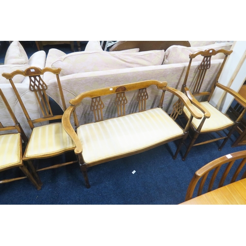 51 - An Edwardian walnut and satinwood inlaid parlour suite consisting a two seater settee, armchair and ... 