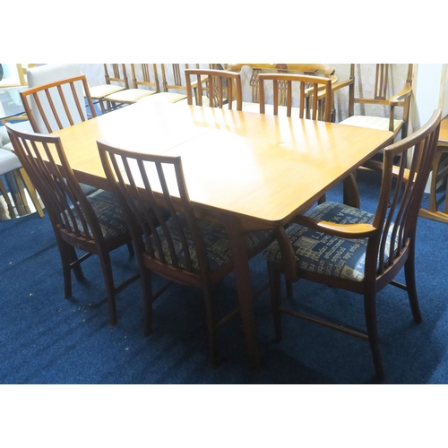 62 - A mid 20th century Scottish teak McIntosh extending dining table and six chairs, table with shaped t... 