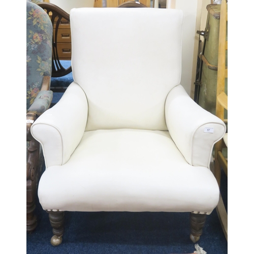 67 - A late Victorian white leather upholstered armchair on turned supports, 92cm high x 81cm wide x 95cm... 