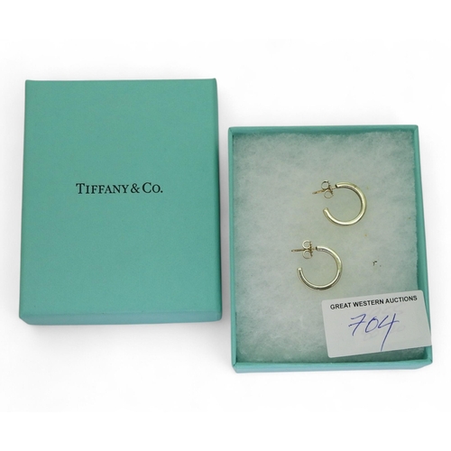 704 - A pair of silver Tiffany & Co hoop earrings, full T&Co hallmarks to both the post and butter... 