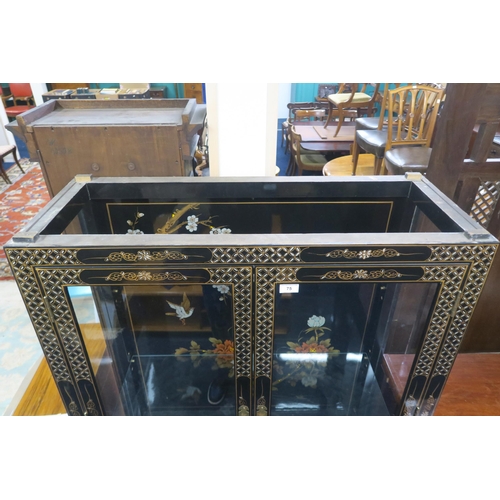 75 - A 20th century Oriental style black lacquer display cabinet with pair of glazed doors over two short... 