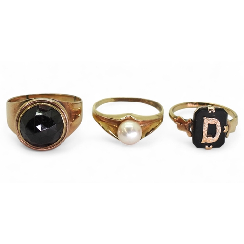 783 - A yellow metal ring set with a garnet, size O1/2, a 9ct gold pearl ring size M1/2, and a signet ring... 