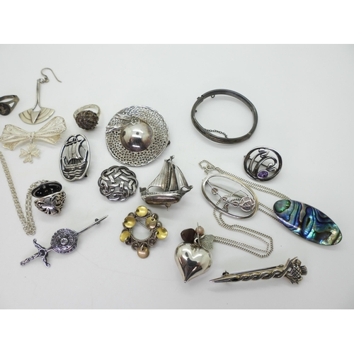 875 - A collection of silver and white metal jewellery to include a Norwegian marriage brooch, Macintosh i... 