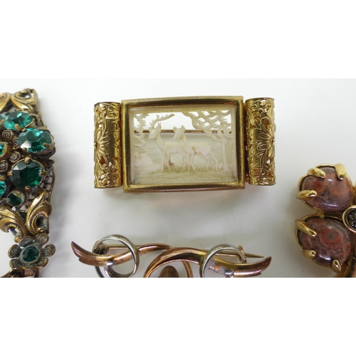 877 - A collection of vintage costume jewellery to include an early plastic deer scene, a base metal Art N... 