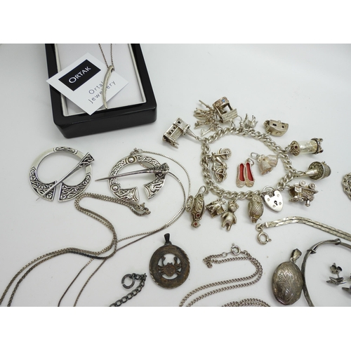 899 - A collection of silver and white metal jewellery to include a silver charm bracelet, with owl and do... 