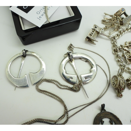 899 - A collection of silver and white metal jewellery to include a silver charm bracelet, with owl and do... 