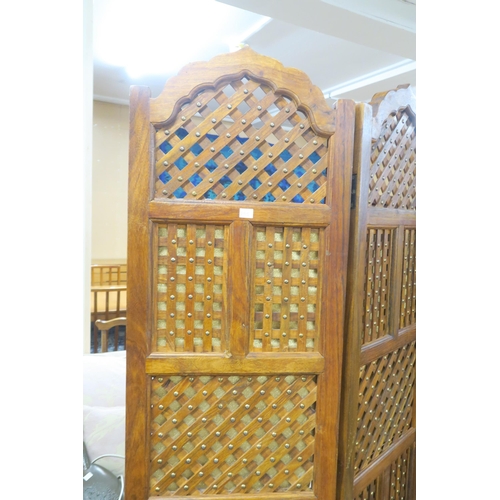 92 - A contemporary Indonesian hardwood four panel room divider with slatted panels with gilt fabric back... 