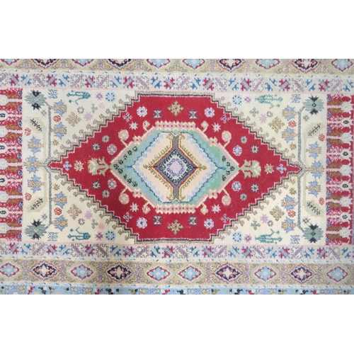 93 - A multicoloured ground Persian rug with red central medallion within numerous multicoloured borders,... 