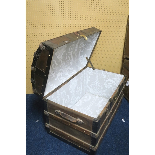 99 - A late 19th/ early 20th century wood bound dome top travel trunk 