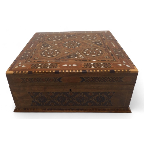 519 - A Middle Eastern box, intricately inlaid with mother of pearl and specimen woods, opening to reveal ... 