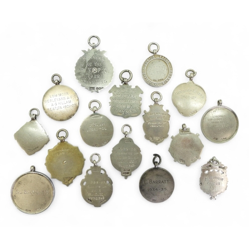 554 - A collection of early-20th century hallmarked silver football fob medals, to include Cumberland Foot... 