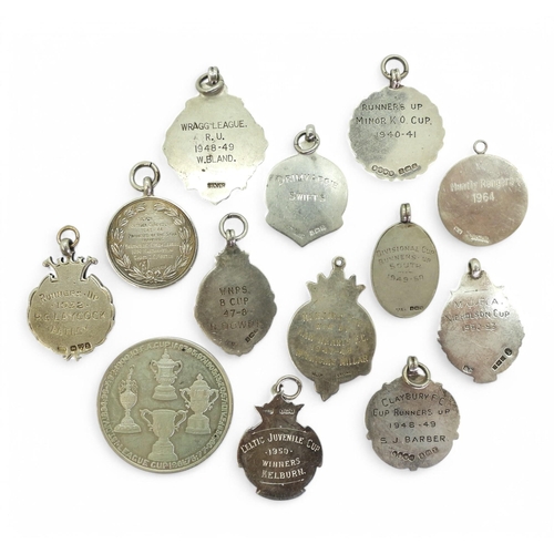 556 - A collection of 1940s/50s-era silver football fob medals, including Ilford & District Football L... 