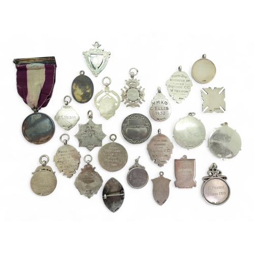 557 - A collection of silver sporting fob medals, late-Victorian and later, including Devon County Golf Cl... 