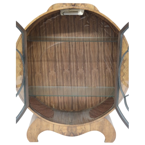 2010 - AN ART DECO CIRCULAR DISPLAY CABINET with a pair of beaded half crescent doors on shaped base with s... 