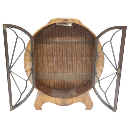 2010 - AN ART DECO CIRCULAR DISPLAY CABINET with a pair of beaded half crescent doors on shaped base with s... 