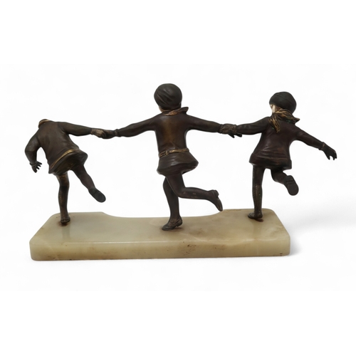 2155 - ALEXANDRE KELETY (HUNGARIAN, 1874-1940)A bronze of three girls, dressed in winter coats and gloves, ... 