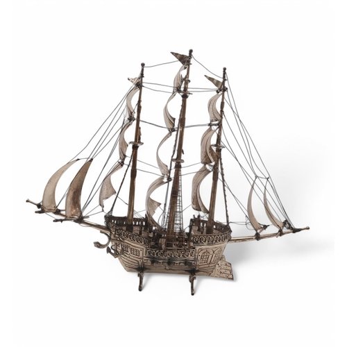 333 - A silver plated nef in the form of a galleon, on dolphin fin supports, 58 x 48cm