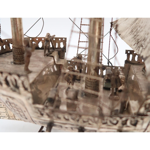 333 - A silver plated nef in the form of a galleon, on dolphin fin supports, 58 x 48cm