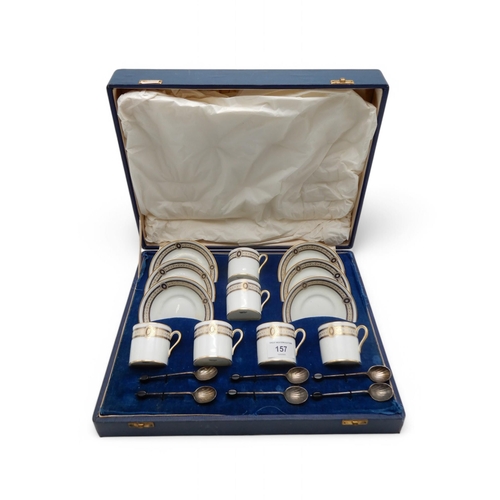 157 - Cased Cauldon coffee cans and saucers with six silver shell spoons