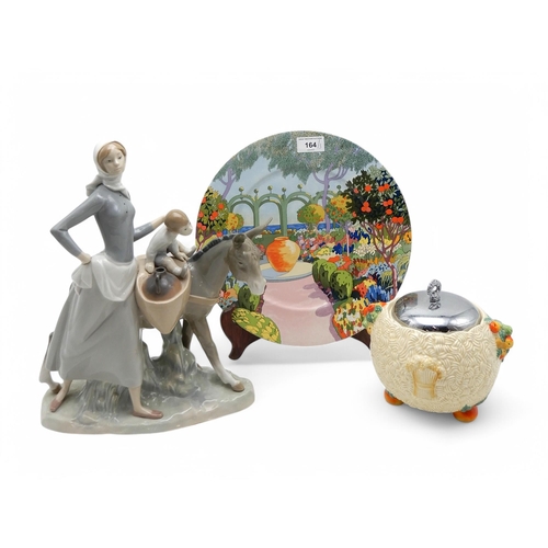 164 - A large Lladro figure of a woman with donkey and child, together with a Clarice Cliff Celtic Harvest... 