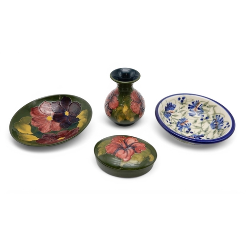 166 - A Moorcroft Hibiscus pattern box and cover and vase, together with a clematis pattern bowl and a Cra... 