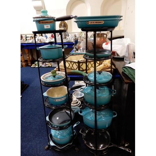 194 - A collection of Le Cruset turquoise (Caribbean) pots and pans and two stands