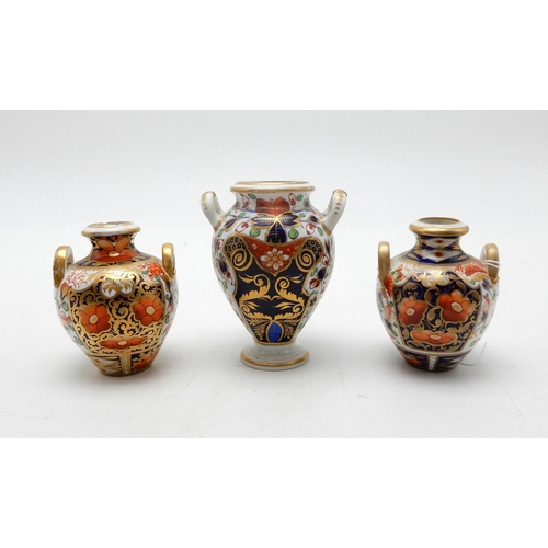 213 - Three Derby urns and a saucer