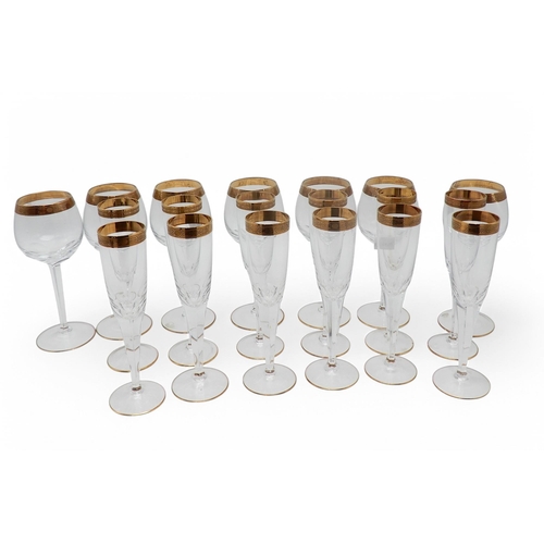 216 - *WITHDRAWN*Champagne flutes and wine glasses with gilt Celtic design to the rim, and further champag... 